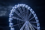 ferris wheel amusement park fair nature heaven clouds stock photo