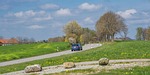 country road rural traffic car automobile trees nature stock photo