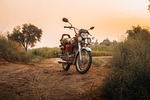 motorcycle bike nature sunset evening dust honda golden stock photo
