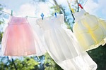 clothesline little girl dresses laundry hang clothespins clean stock photo