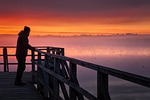 man pier silhouette sunrise fog mystical nature landscape stock photo