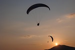 paragliding parachute sunset nature holiday adventure basejump stock photo