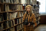 woman photographer library retro vintage education journalist shelves stock photo