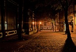 alley street night evening city urban town lamps stock photo